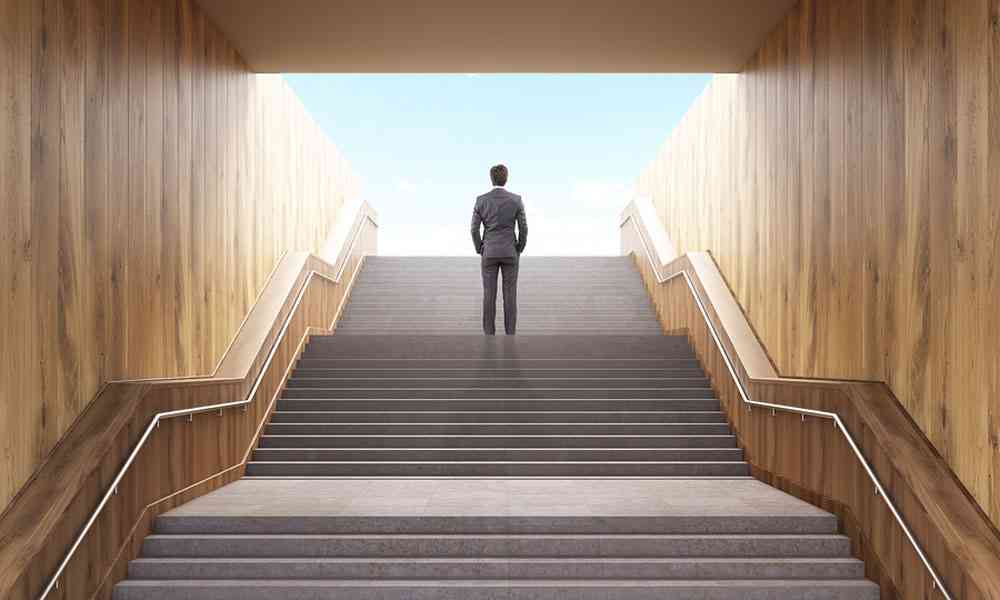 man standing at the top of a staircase looking out