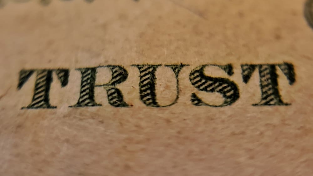 Photo of the word "trust" on U.S. currency. Photo by Joshua Hoehne on Unsplash